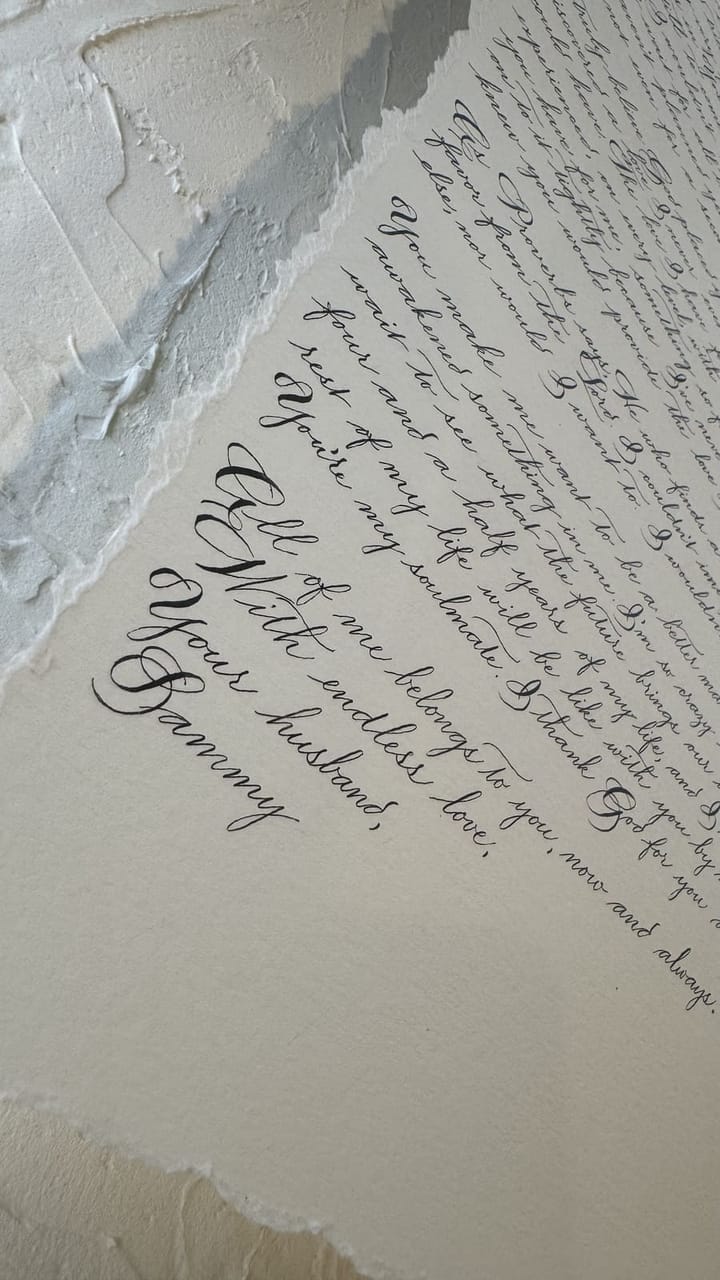 A hand-lettered anniversary letter on deckled-edge paper