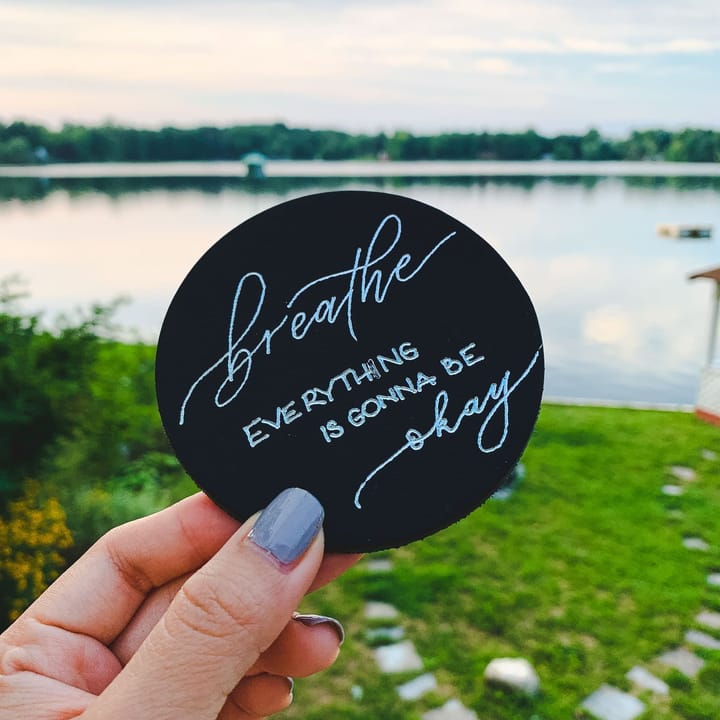 A round coaster hand-lettered breathe, everything is gonna be okay