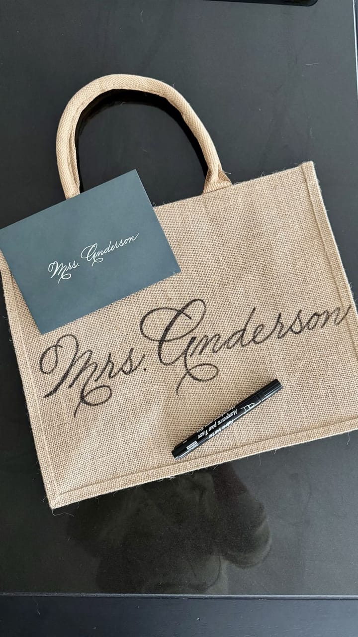 Jute tote bag hand-lettered 'Mrs. Anderson' beside a matching place card