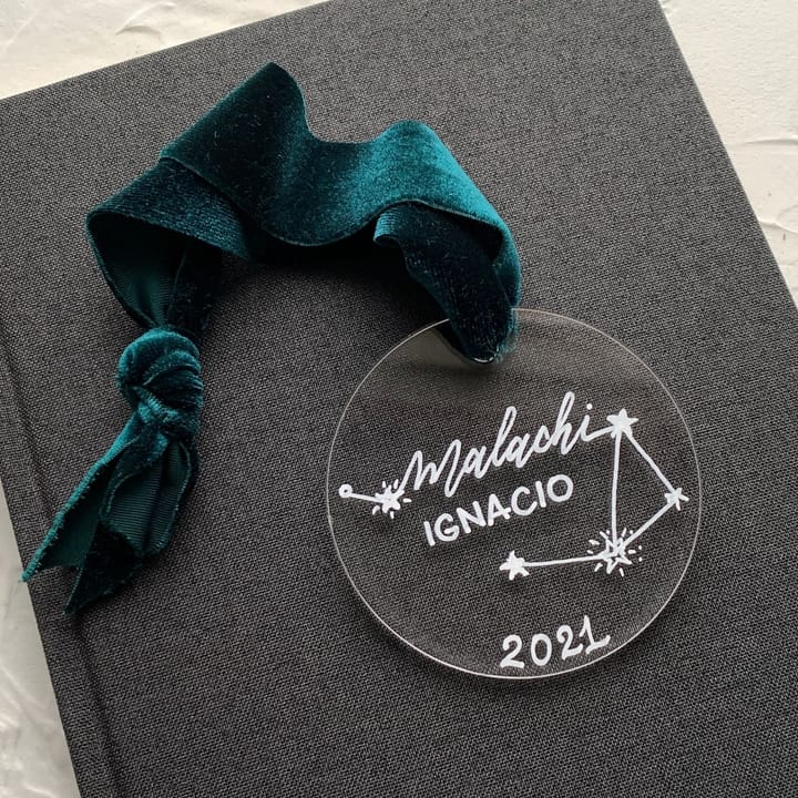 Clear acrylic ornament with a hand-drawn constellation and a child's name and birth year
