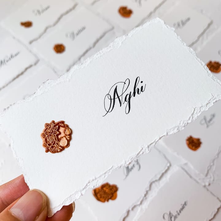 Place card on deckled-edge paper with a copper wax seal