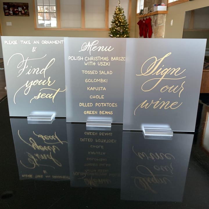 Frosted acrylic reception signs reading Find Your Seat, Menu, and Sign Our Wine