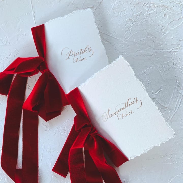 Vow books tied with red velvet ribbon